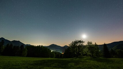 Wall Mural - star in starry night sky moving over countryside nature at full moon astronomy time lapse night to d