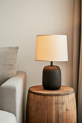 Poster - A nostalgic living room scene with a wooden barrel used as a coffee table and a worn wooden side table holding a classic lamp, creating a timeless look,