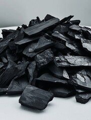 Poster - Close-up of a pile of dark gray charcoal pieces.
