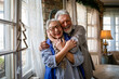 © NDABCREATIVITY - Happy senior adult mature pensioner couple hugging, bonding, thinking of good future
