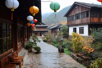 Poster - Cobblestone pathway in a quaint village with traditional wooden houses, colorful lanterns, and autumn foliage.
