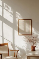 Wall Mural - Soft natural light illuminates a minimalist Nordic-style picture frame on a white wall, complemented by a small potted plant. The clean lines enhance a sense of tranquility and modernity