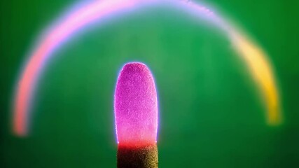 Poster - Purple plasma forms a fluctuating arc over the tip of a matchstick against a vibrant green screen background, ideal for chroma key compositing