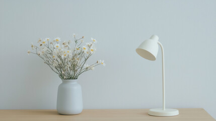 Poster - minimalist interior scene featuring vase with flowers and lamp. calming blue hue enhances serene atmosphere
