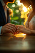 © JulieMeneghin - Photo d'un gros plan romantique sur les mains d’un couple avec alliances et lumière naturelle
