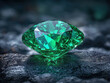 Sparkling emerald gemstone close-up on smooth dark surface with cinematic effect