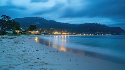 Poster - Twilight Beach Landscape Captured with Long Exposure Technique Showcasing Calm Waters and Coastal Lights