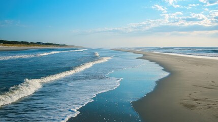 Aufkleber - Turquoise ocean waves softly wash over a serene sandy beach under a clear blue sky