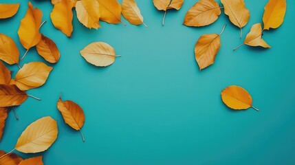 Aufkleber - Scattered yellow autumn leaves on a vivid turquoise background creating a vibrant seasonal backdrop for creative projects