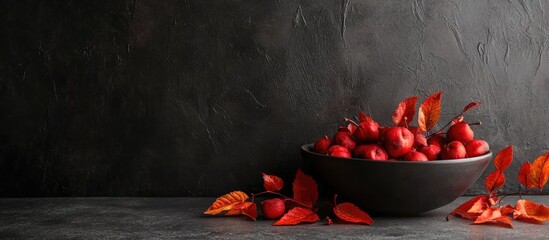 Aufkleber - Autumn still life arrangement featuring red and orange leaves with a dark gray background and a black bowl filled with red apples, perfect for text overlay.