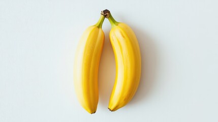 Aufkleber - Two Ripe Yellow Bananas Placed on a Clean White Background Symmetrically Arranged for Freshness and Healthy Lifestyle Concept