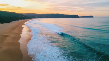 Poster - Serene turquoise waves lapping at golden sandy beach with a tranquil pastel sky at sunset over a picturesque coastal landscape