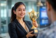 © CamClips - Woman holding a trophy, with an expression of achievement
