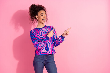 Wall Mural - Photo of shiny attractive lady dressed purple sweatshirt pointing two fingers empty space isolated pink color background