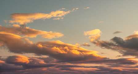 Wall Mural - beautiful orange sunset clouds on the blue sky. sky background.