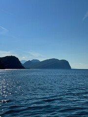 Wall Mural - blue sea, rocks, clear sky horizon.