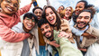© Davide Angelini - Multicultural young people smiling together at camera outside - Happy friends taking selfie pic with smart mobile phone device - College students having fun - Youth community concept