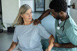 © zinkevych - Medical man offering physiotherapy treatment to patient assisting with shoulder trauma recovery