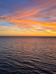 Wall Mural - dusk sky clouds over calm sea.