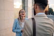 © Zamrznuti tonovi - Young businesswoman laughing with colleague outdoors