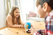 © Lumos sp - child girl boy education globe earth school map kid brother sister game playing classroom learning global geography travel science student continent planet exploration