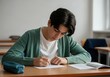 © Sandor - Teenager student writing notes during exam at school classroom