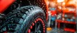 © ngstock - Close-Up of a Wet Tire with Water Droplets and a Workshop Background