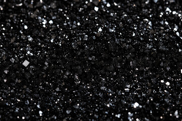 Poster - Black glitter surface sparkling with subtle reflections, creating a luxurious and festive backdrop for various design projects