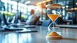 © 怡如 柯 - Hourglass on Office Desk with Professionals Working in Background