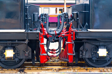 Chain coupler connecting freight wagons retro steam locomotives close up, large wagon buffers visible.