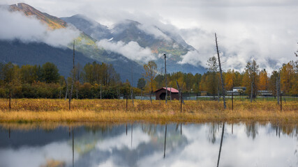 Wall Mural - scenic panoramic view of reflection lake in alaska during autumn time.