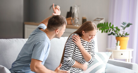 Wall Mural - Angry husband scolding his wife at home