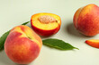 © Pixel-Shot - Sweet peaches and leaves on light background