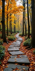 Wall Mural - A stone pathway winds through a forest, surrounded by autumn leaves