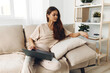 © SHOTPRIME STUDIO - Happy Freelance Woman Typing on Laptop in Cozy Living Room, Enjoying Modern Technology