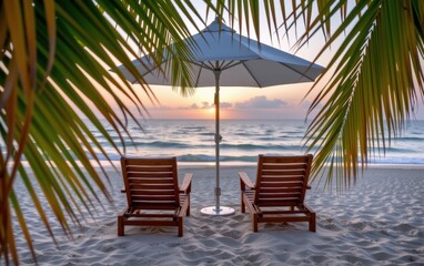 Wall Mural - A tranquil beach scene at sunrise with two wooden lounge chairs positioned under a white umbrella.