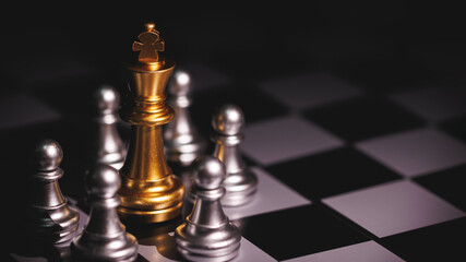 Golden king chess pieces surrounded by silver pawn in concept of leadership and victory.