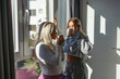 © Alberto - Lesbian couple drinking coffee by the window on valentine's day