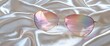 © ABIDZAR ALFAREZ - Pink aviator sunglasses on silk fabric.