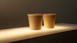 © Thirakun - Eco-friendly paper cup on a white surface illuminated for modern product marketing