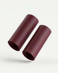 Fototapete - Burgundy paper tube mockups gently floating in front view on a white backdrop with soft light and minimal shadows.