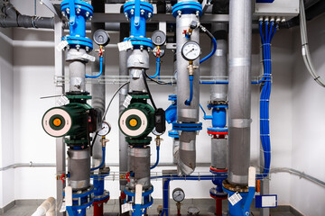 Industrial water pumping system showcasing blue and green components in a modern facility