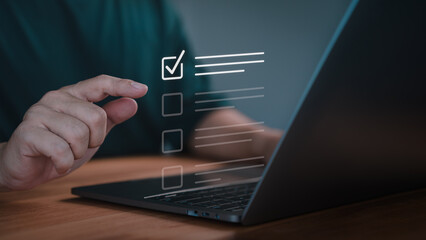 Fototapete - Hand pointing at a virtual checklist with complete task on a laptop, symbolizing task management, customer service, quality control, productivity and efficient work processes in a digital environment.