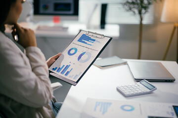 Aufkleber - Professional female executive analyzing financial reports, studying performance metrics on digital screen with corporate background
