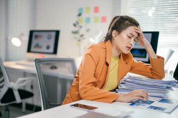 Poster - Young office worker suffering from headache while working with documents and computer at workplace
