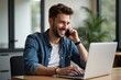 © Fazla - Portrait of Young Smiling Cheerful Entrepreneur in Casual Office Making Phone Call While Working with Laptop Generative AI