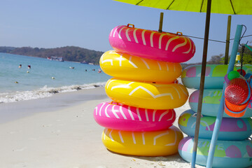 Wall Mural - Inflatable rings on the beach. Summer concept