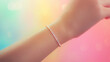 © Nichapa888 - close-up of a delicate human wrist adorned with a sparkling bracelet, against a soft, gradient background