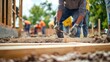© phy - A volunteers helping to construct a new community building, working with tools and building materials