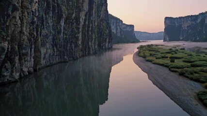 Poster - Majestic river flows through stunning cliffs at sunrise in a serene natural landscape